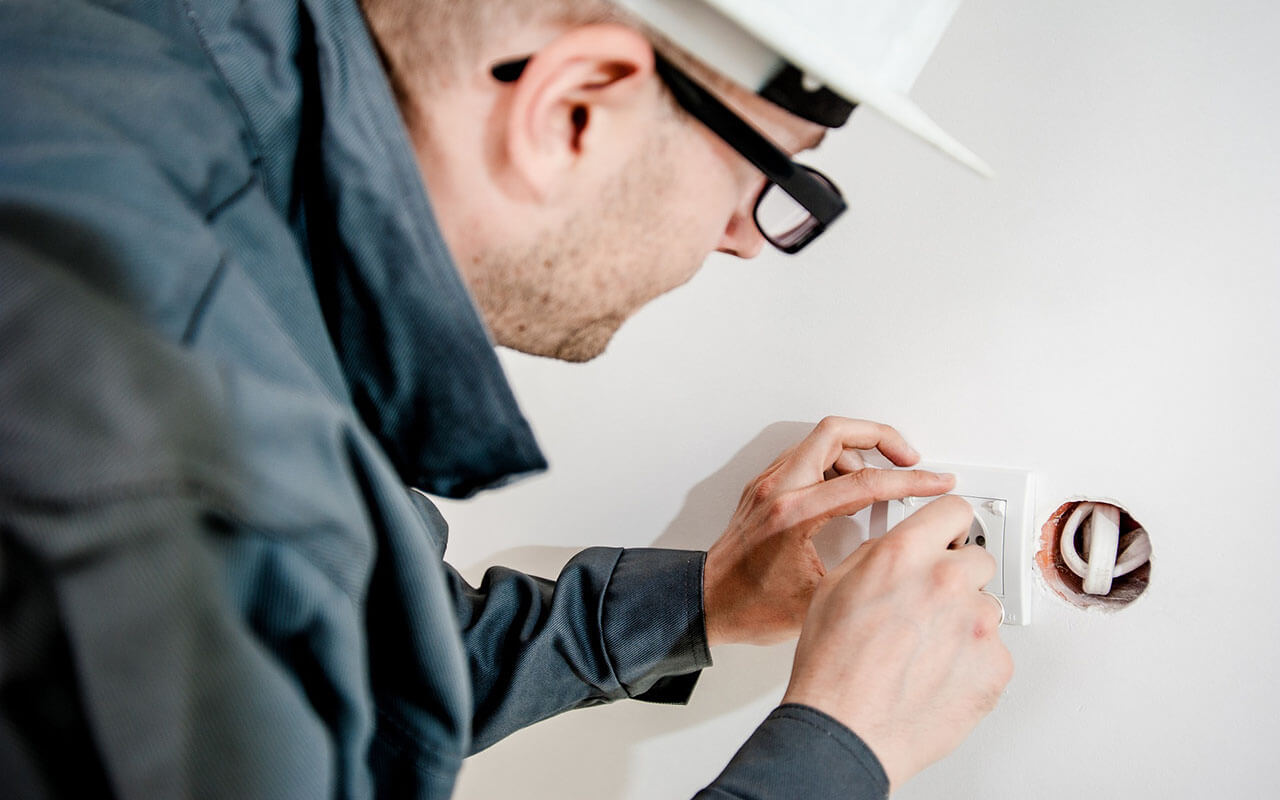 electrician installs a new outlet